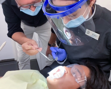 dental assistant and dentist in cabo san lucas doing dental work on a young woman